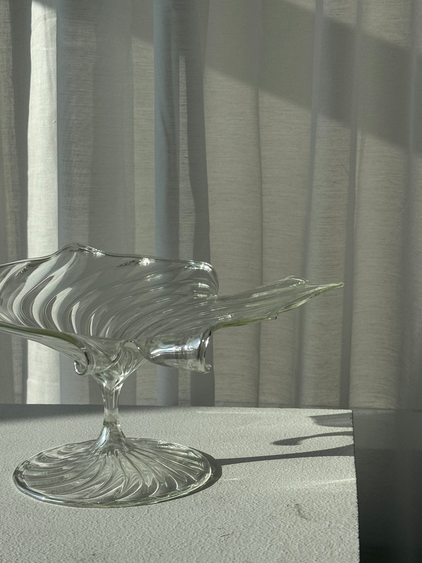 Swirling glass stand