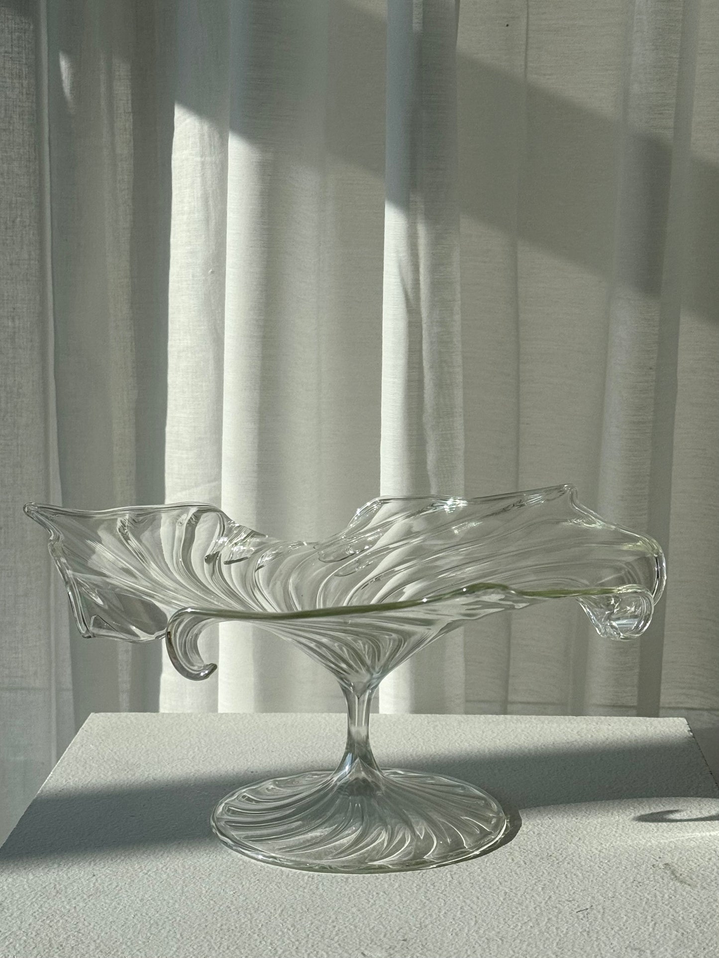 Swirling glass stand
