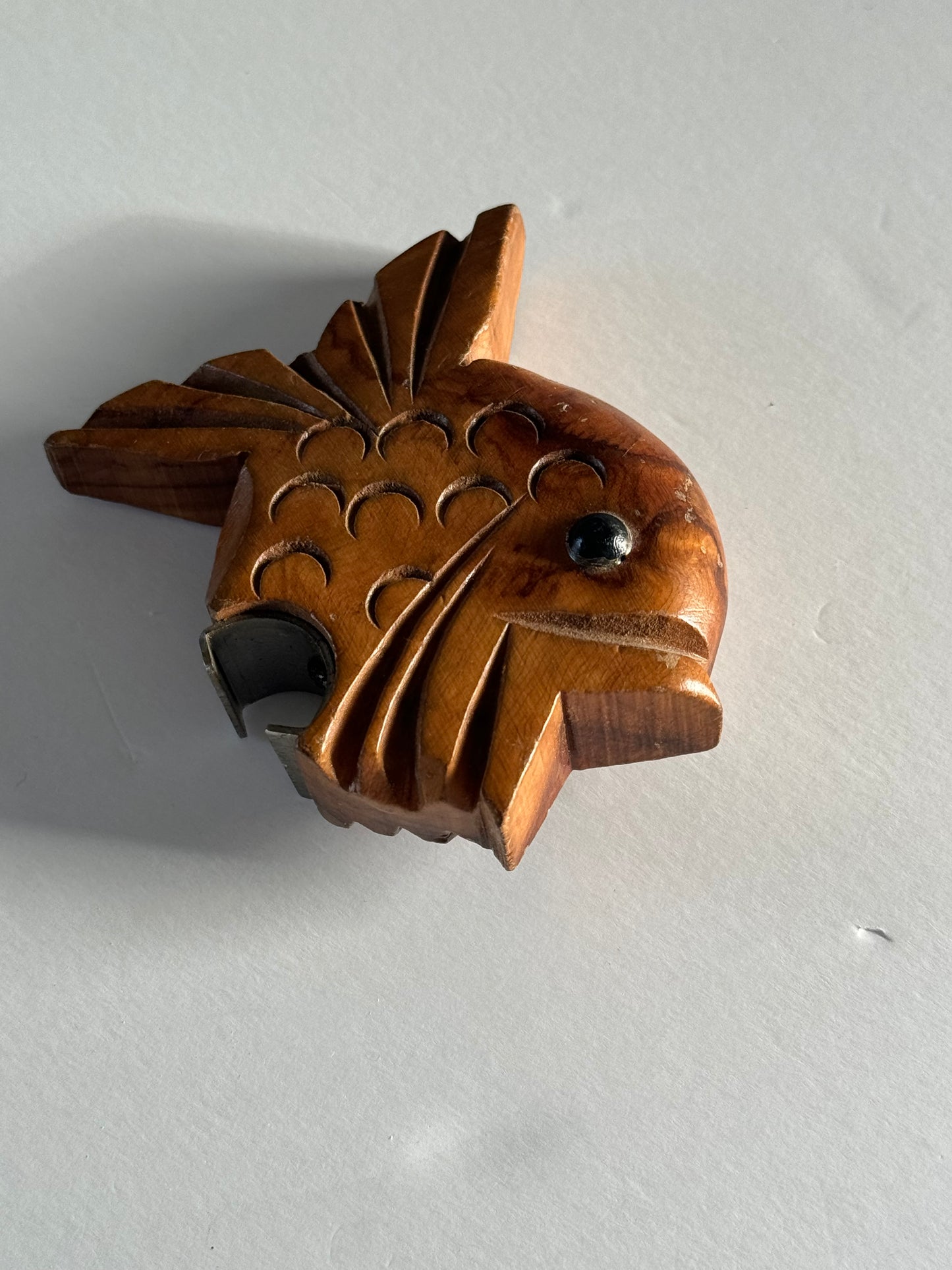 Wooden fish bottle opener.