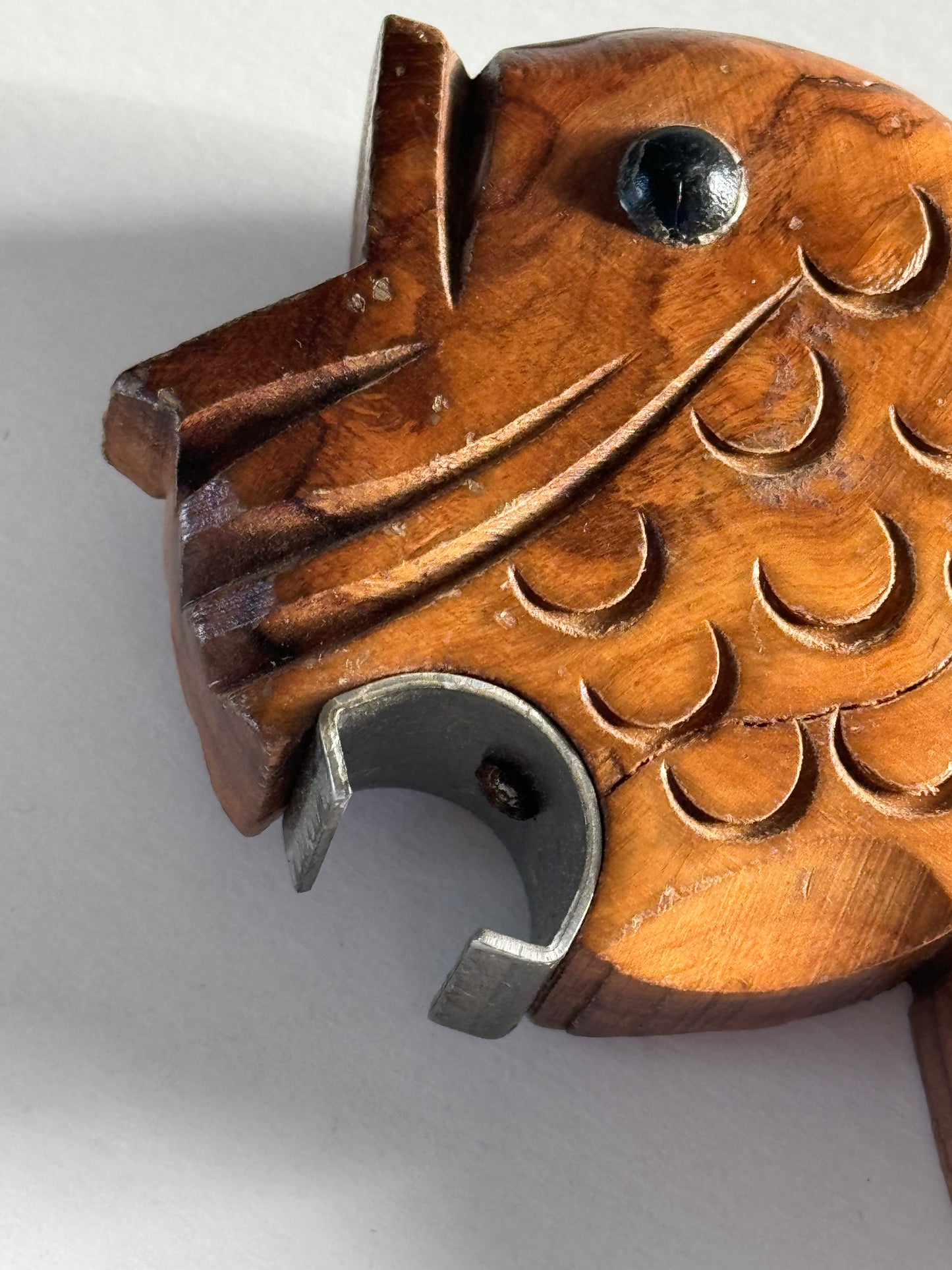 Wooden fish bottle opener.